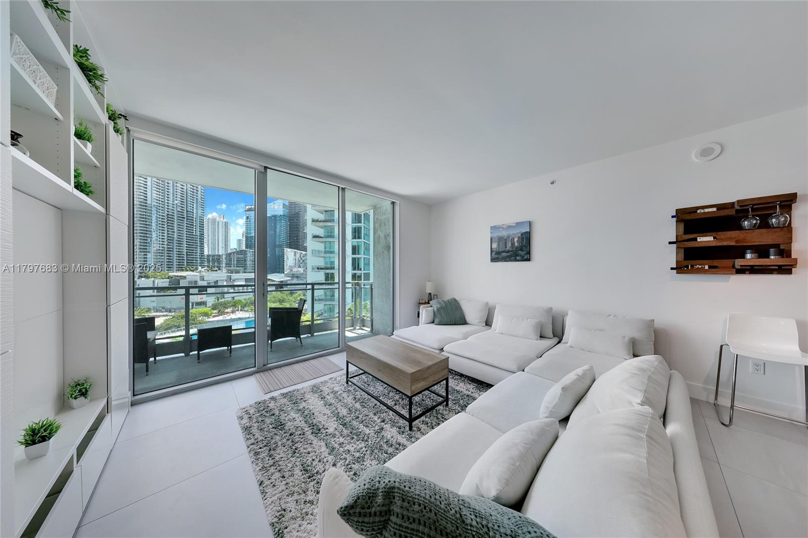 90 Southwest 3rd Street, Unit 1514 Miami, FL 33130 - Photo 6 of 25 a living room with furniture and a flat screen tv