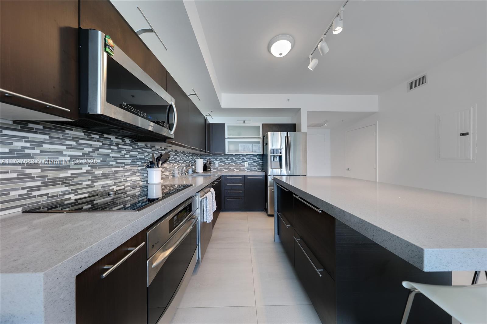 90 Southwest 3rd Street, Unit 1514 Miami, FL 33130 - Photo 7 of 25 a kitchen with stainless steel appliances a sink and stove