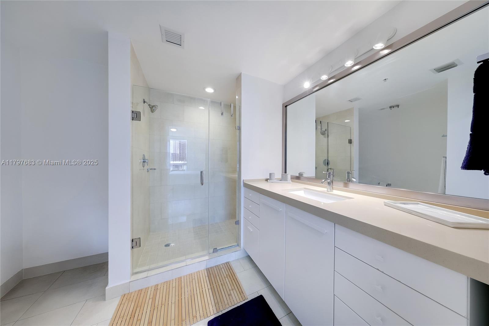 90 Southwest 3rd Street, Unit 1514 Miami, FL 33130 - Photo 9 of 25 a bathroom with a shower sink and mirror