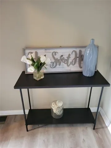 a table with a vase and flowers on it