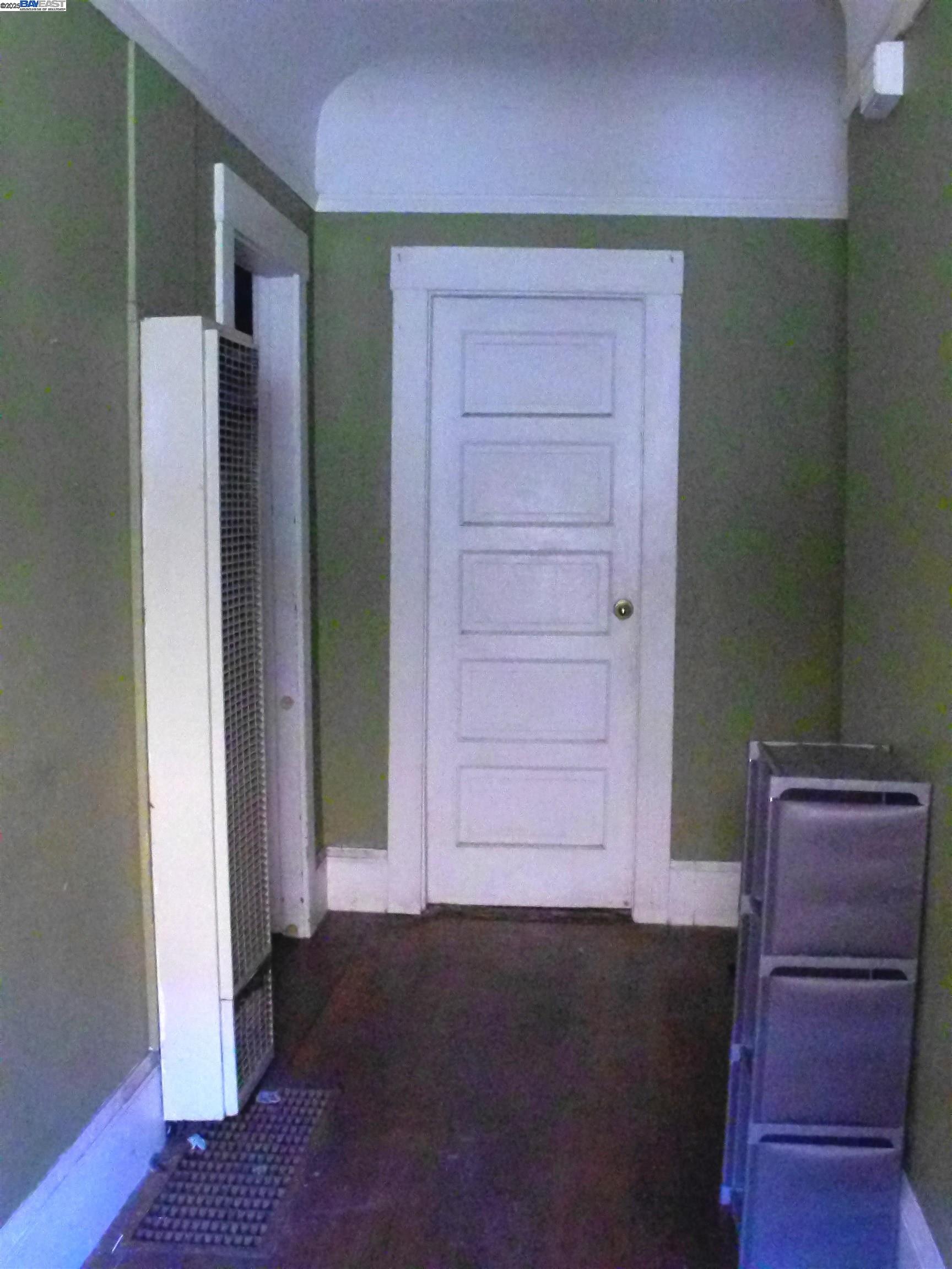 577 48th Street Oakland, CA 94609 - Photo 11 of 11 an empty room with wooden floor closet and windows