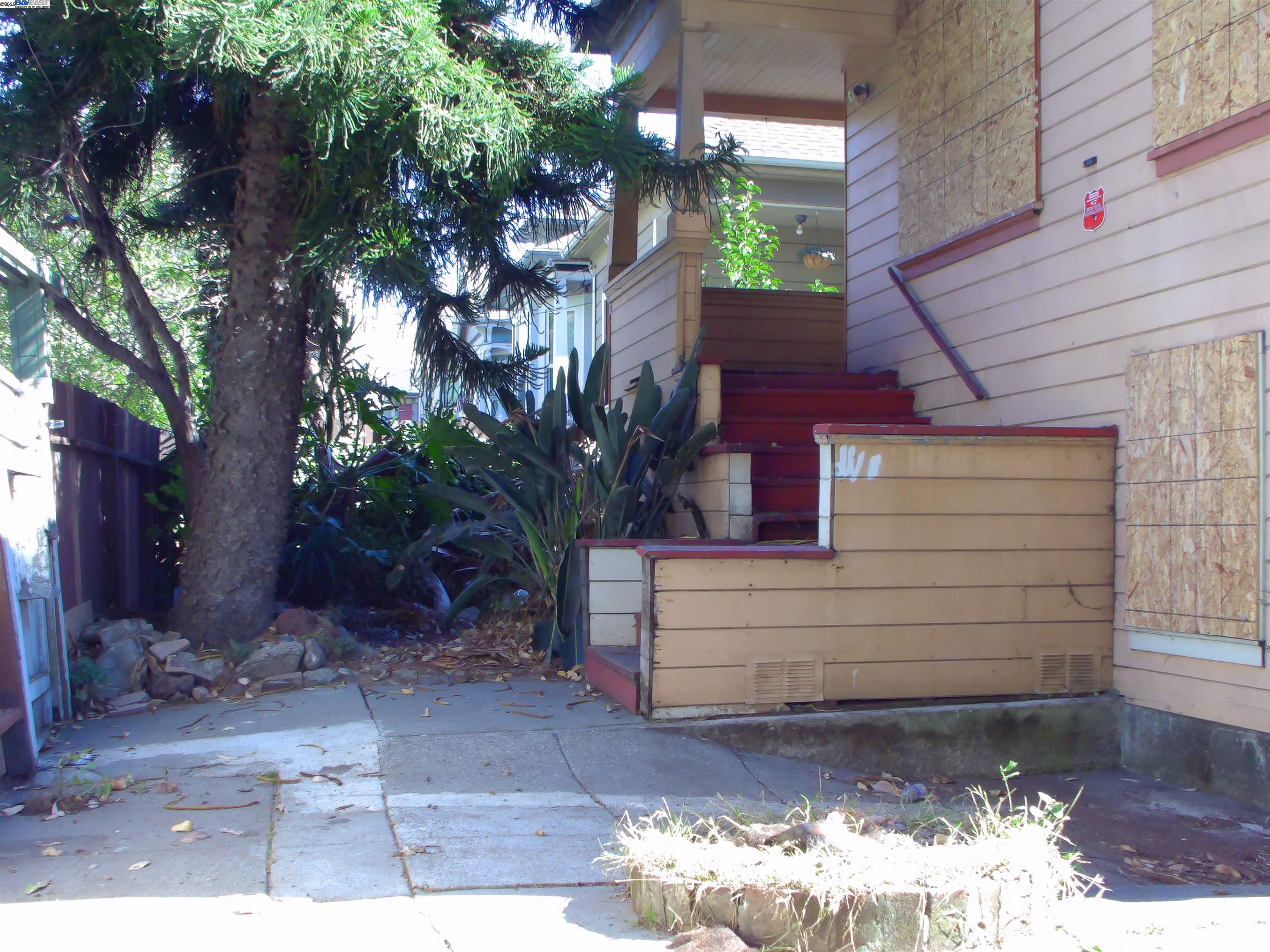 577 48th Street Oakland, CA 94609 - Photo 3 of 11 a view of a house with a yard and tree s
