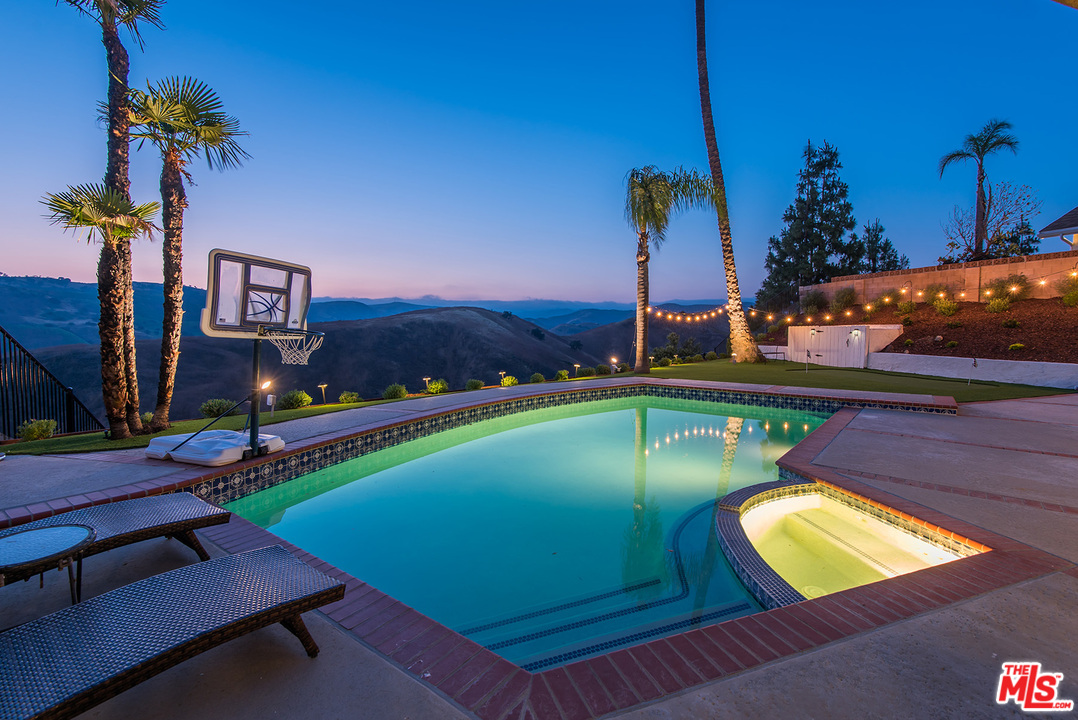 a view of a swimming pool with an outdoor seating
