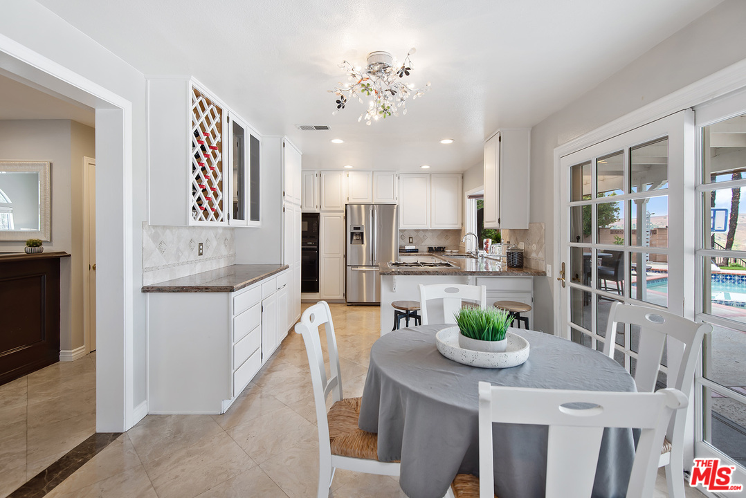 26021 Farmfield Road Calabasas, CA 91302 - Photo 14 of 50 a kitchen with white cabinets and refrigerator
