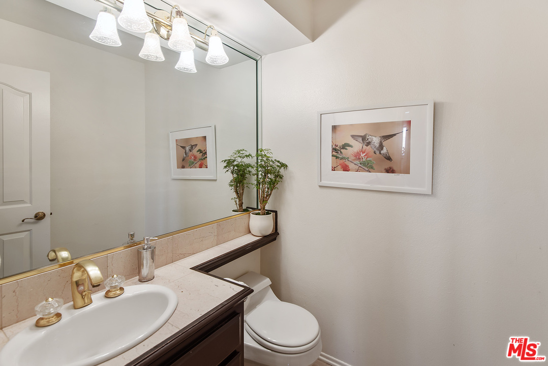 26021 Farmfield Road Calabasas, CA 91302 - Photo 17 of 50 a bathroom with a sink vanity mirror and toilet