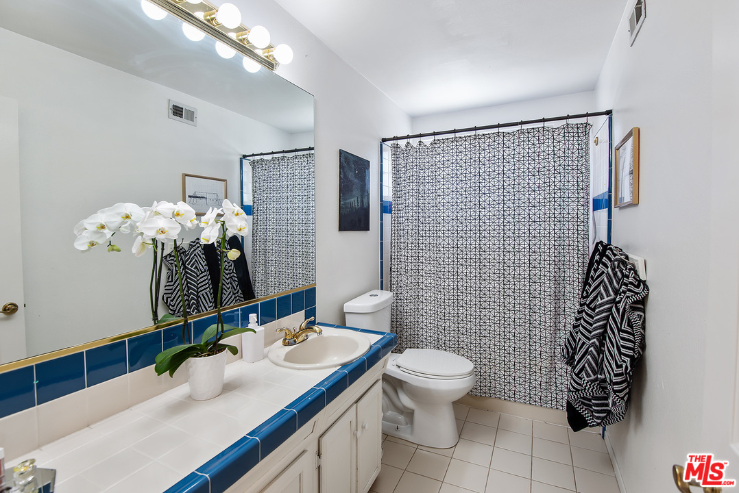 26021 Farmfield Road Calabasas, CA 91302 - Photo 24 of 50 a bathroom with a sink a toilet and mirror