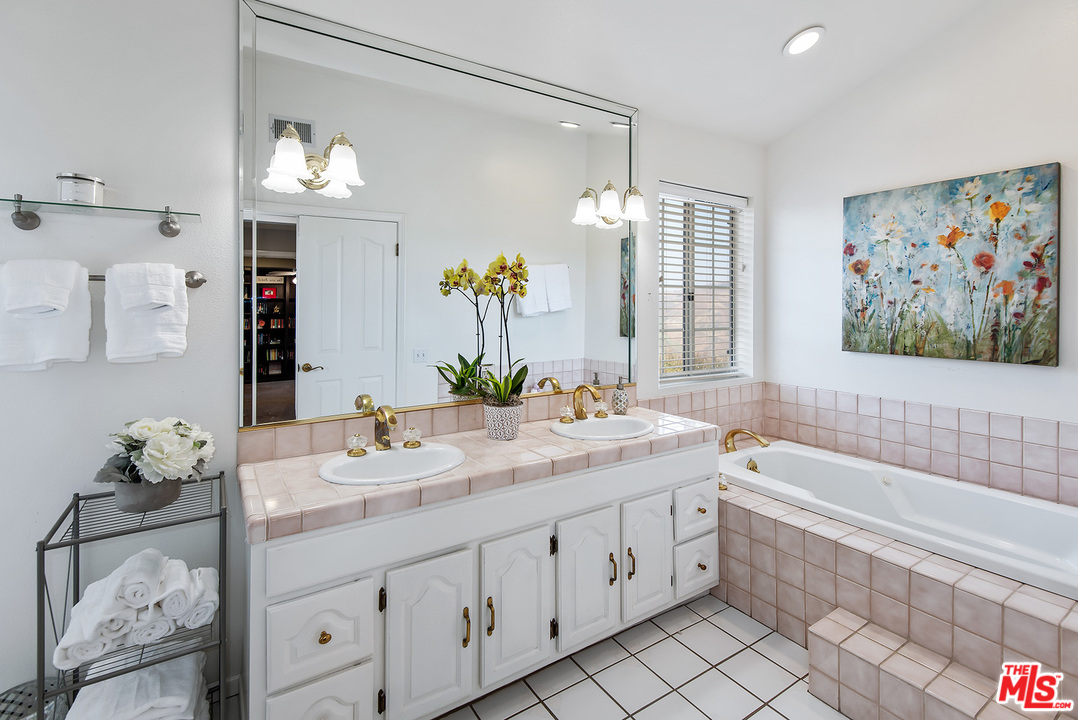 26021 Farmfield Road Calabasas, CA 91302 - Photo 34 of 50 a bathroom with a granite countertop sink a toilet a large mirror and shower