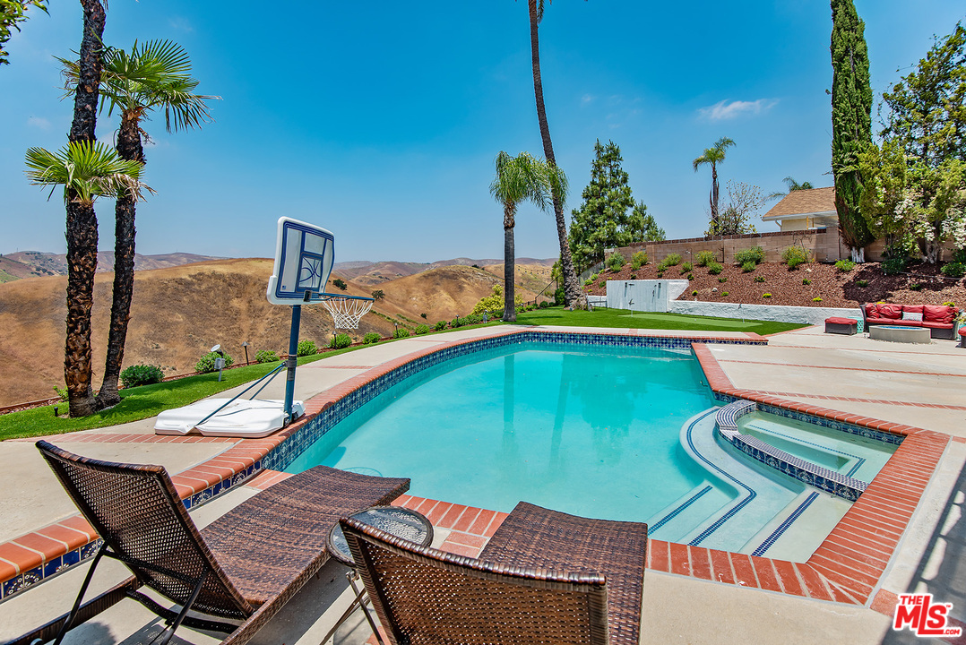 26021 Farmfield Road Calabasas, CA 91302 - Photo 44 of 50 a view of a swimming pool with a lounge chairs