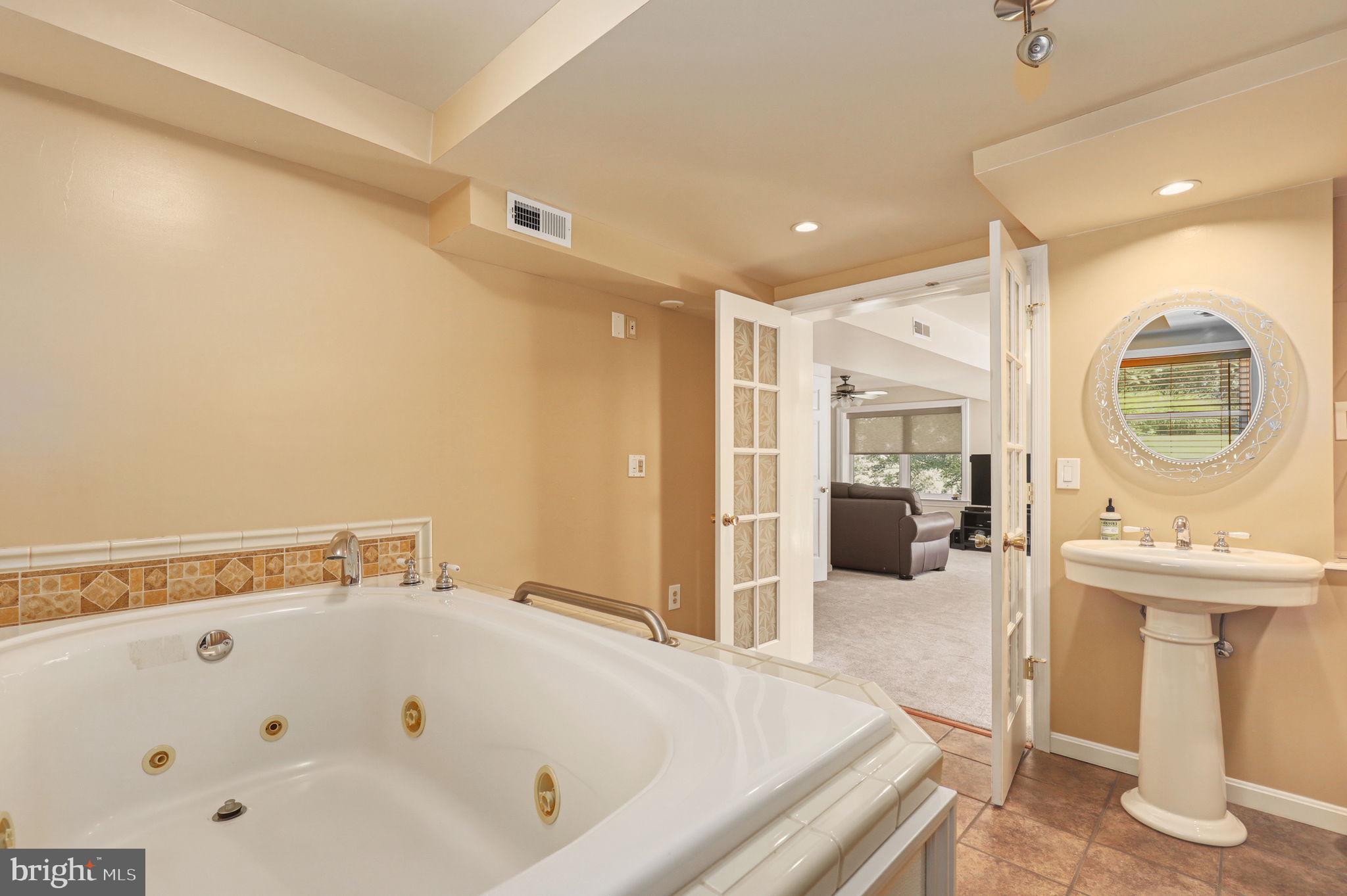 6336 Boyers Mill Road New Market, MD 21774 - Photo 31 of 49 a bathroom with a tub a sink and mirror
