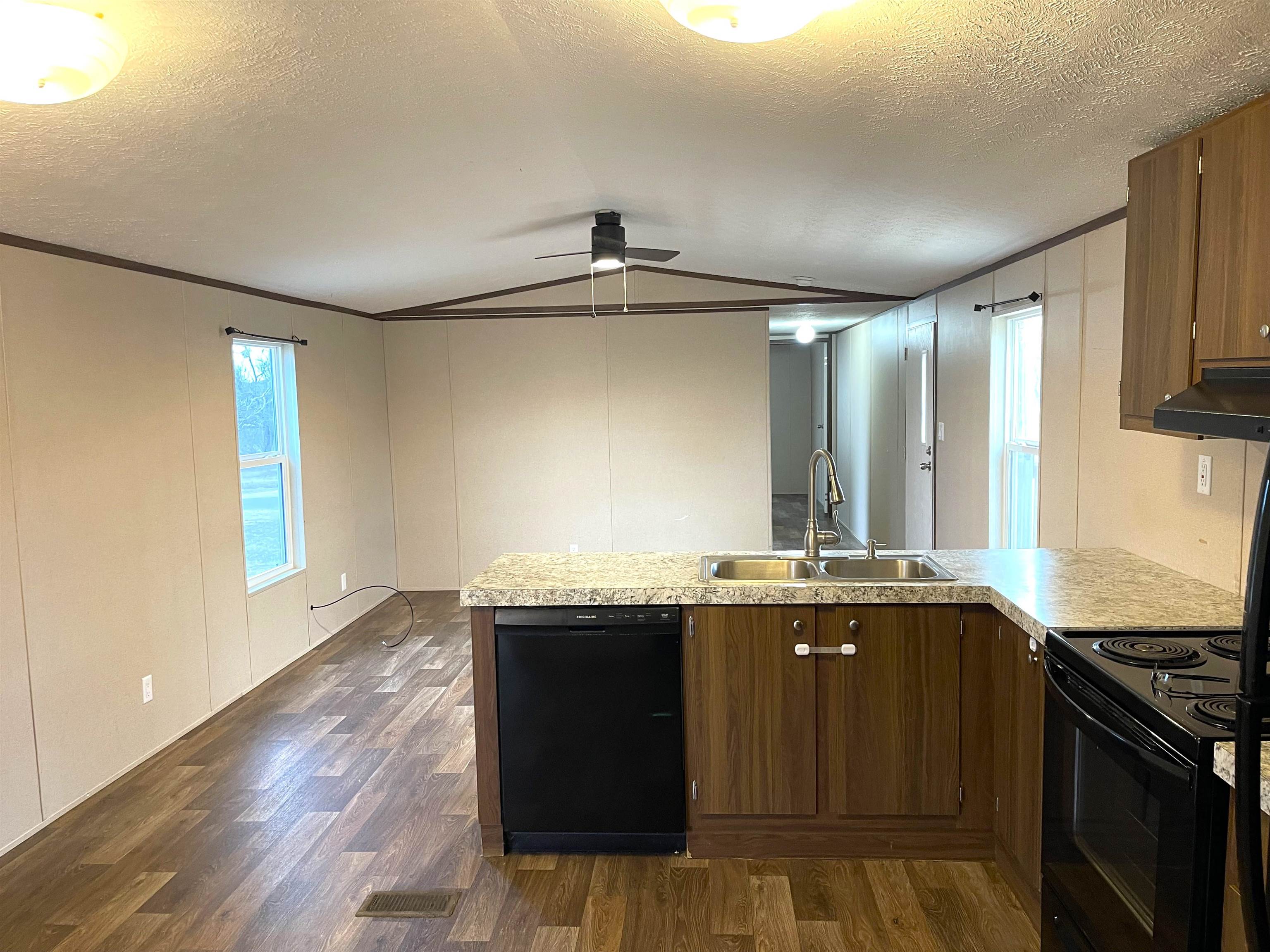 802 East Collins Street Llano, TX 78643 - Photo 3 of 14 a kitchen with granite countertop a sink and a stove