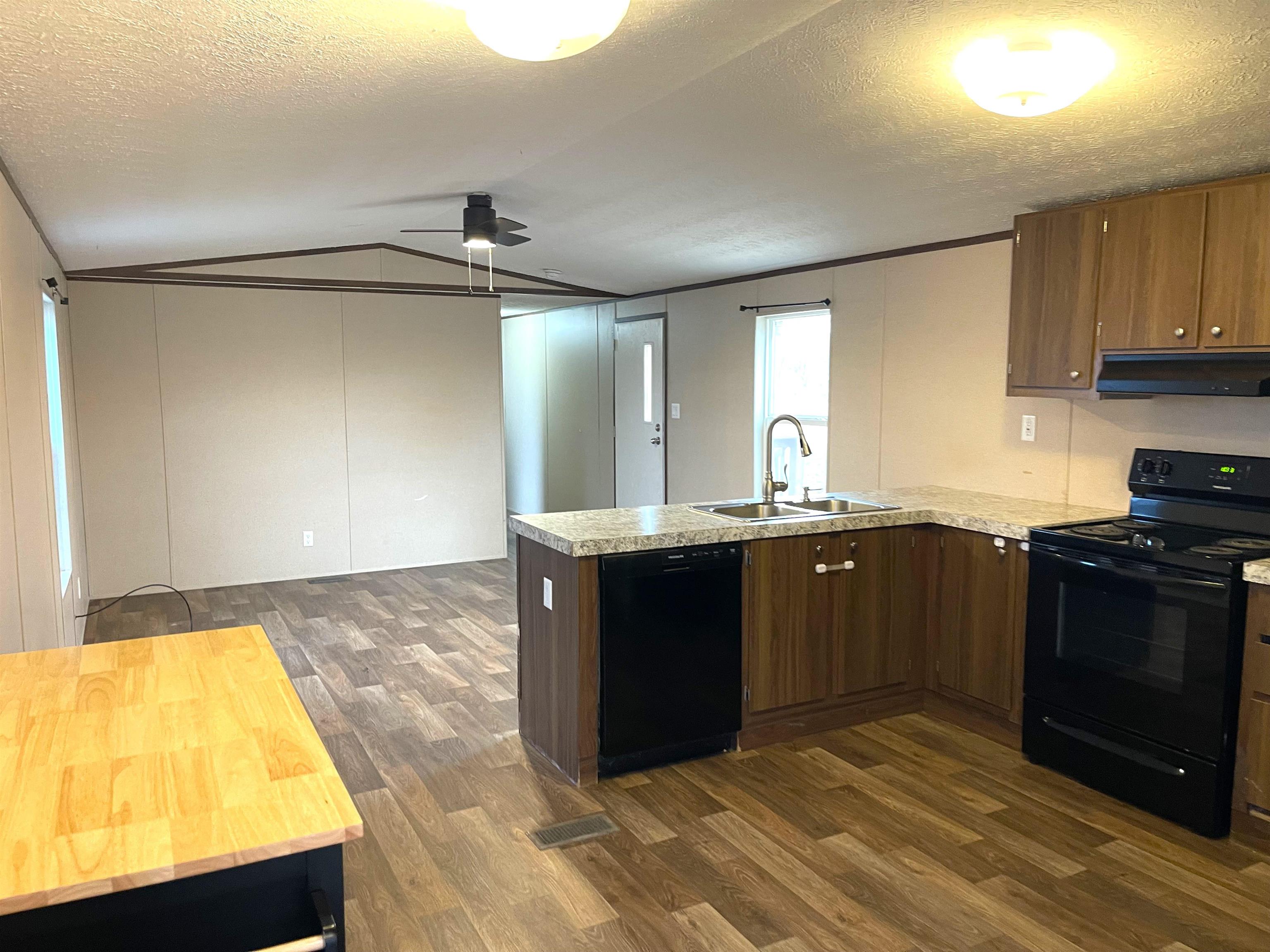 802 East Collins Street Llano, TX 78643 - Photo 4 of 14 a kitchen with stainless steel appliances granite countertop a sink and a stove