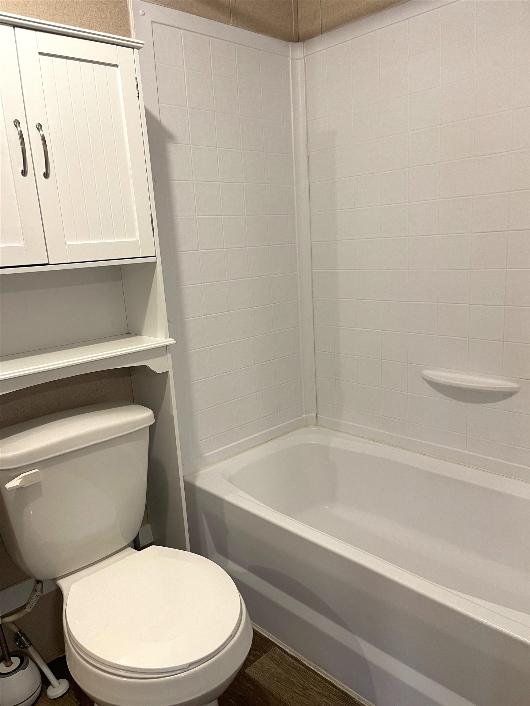 802 East Collins Street Llano, TX 78643 - Photo 9 of 14 a white toilet sitting next to a bath tub