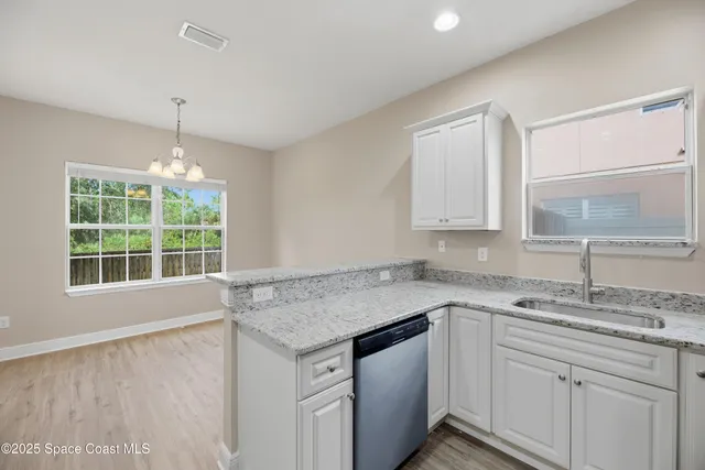 a bathroom with a granite countertop toilet and a sink