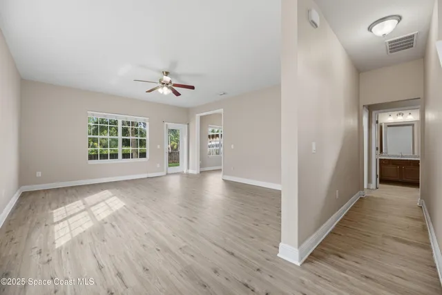 wooden floor in an empty room with a window
