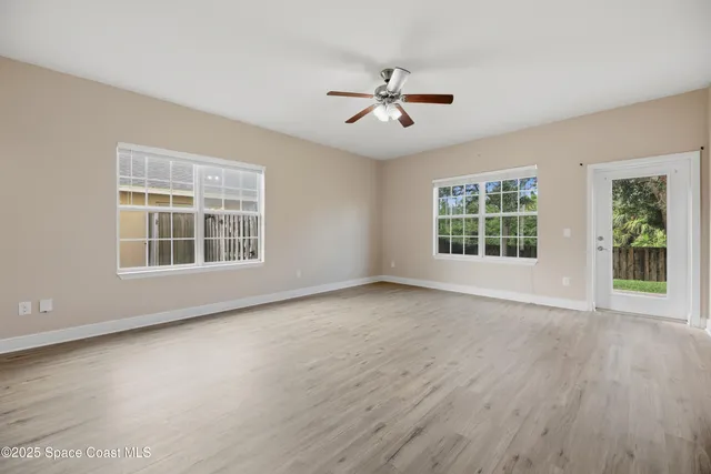 a view of a livingroom with a ceiling fan and window