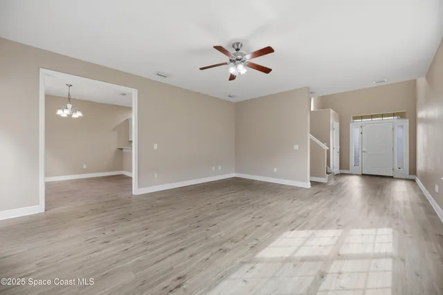 a view of a kitchen with a sink dishwasher a stove top oven and wooden floor
