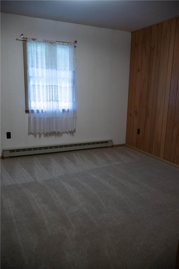 134 Bangor Junction Road Bangor, PA 18013 - Photo 11 of 18 Plush carpeting and natural wood paneling bring warmth to this cozy bedroom space.
