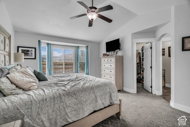 12992 West Geronimo Road Riverton, UT 84096 - Photo 10 of 25 Recessed bay window, vaulted ceiling, ceiling fan, carpet flooring, and an arched doorway