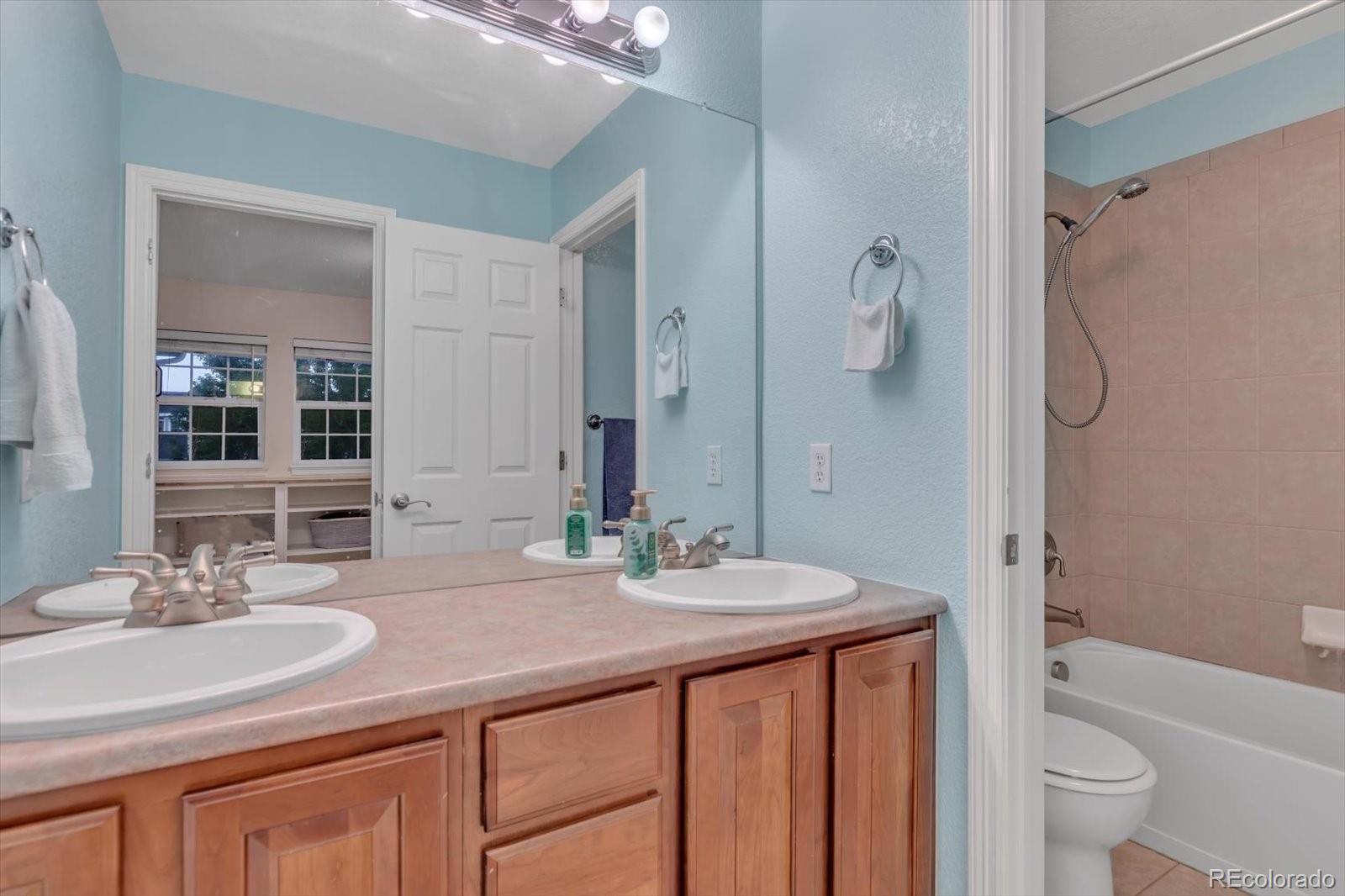 4786 Rabbit Mountain Road Broomfield, CO 80020 - Photo 26 of 41 a bathroom with a sink a toilet and shower