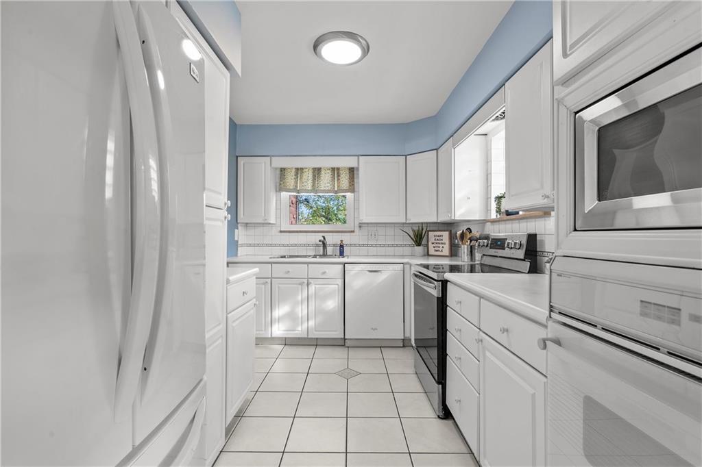 100 Circle Drive Pittsburgh, PA 15237 - Photo 12 of 31 a kitchen with a sink window and cabinets