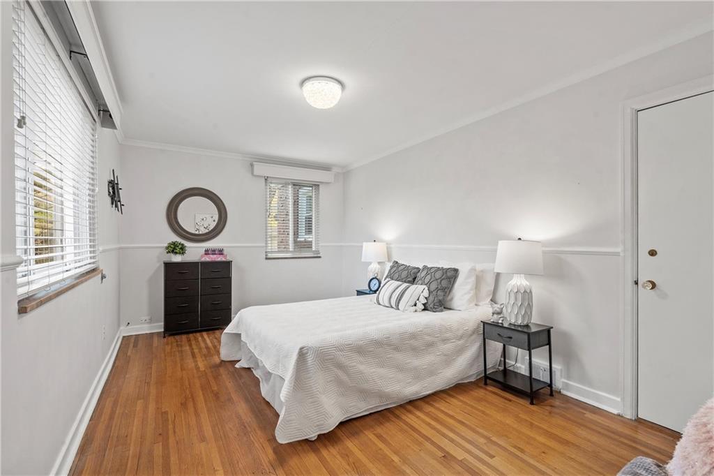100 Circle Drive Pittsburgh, PA 15237 - Photo 17 of 31 a bedroom with a bed and a lamp on dresser with wooden floor