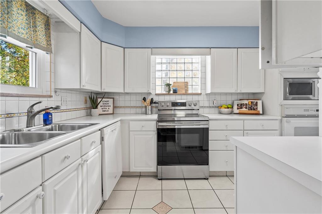 100 Circle Drive Pittsburgh, PA 15237 - Photo 10 of 31 a kitchen with cabinets appliances a sink and a window