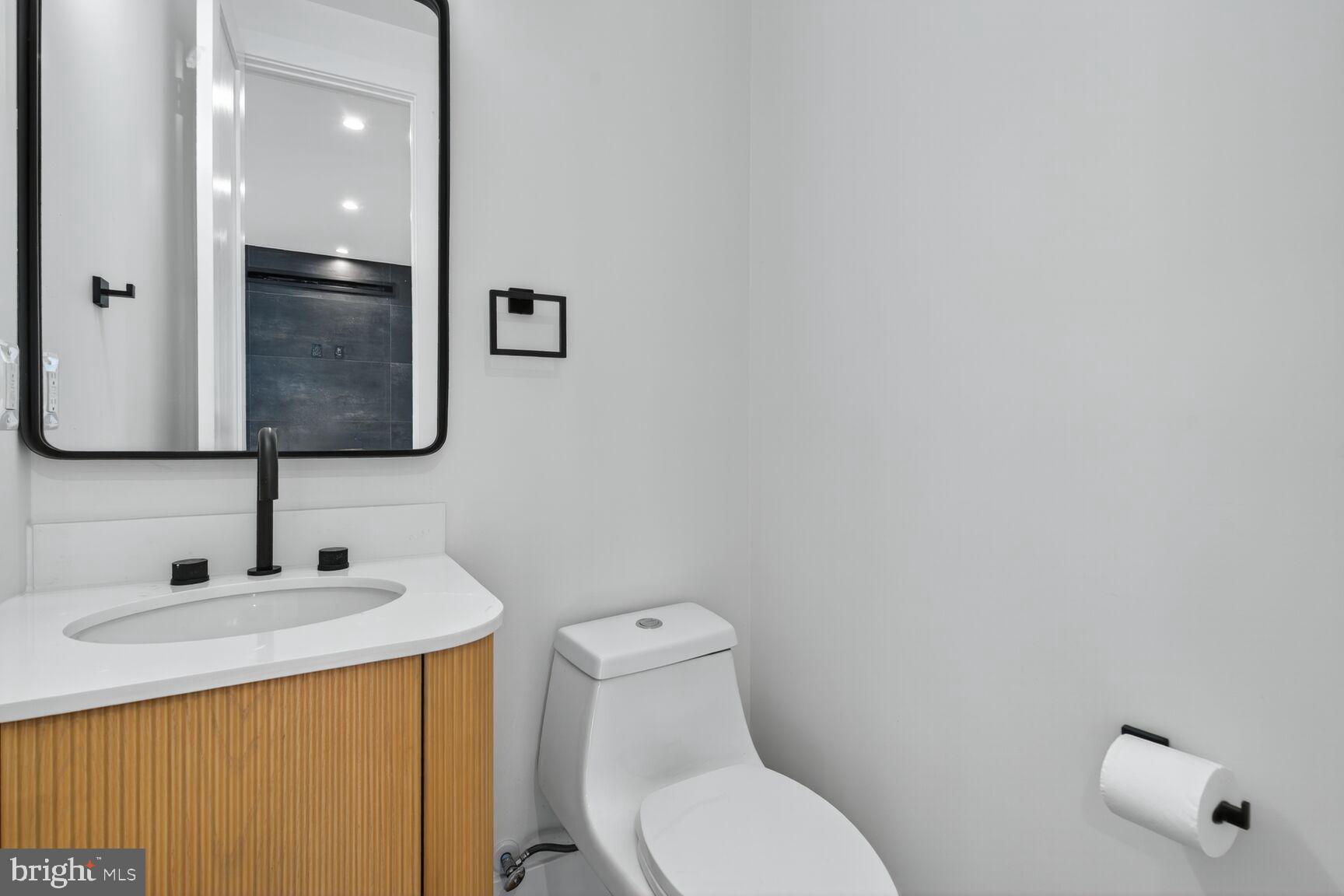 1209 Decatur Street Northwest Washington, DC 20011 - Photo 18 of 54 a bathroom with a toilet sink and mirror