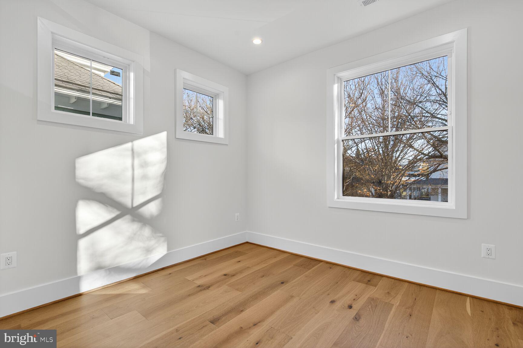 1209 Decatur Street Northwest Washington, DC 20011 - Photo 21 of 54 a view of an empty room with wooden floor and a window