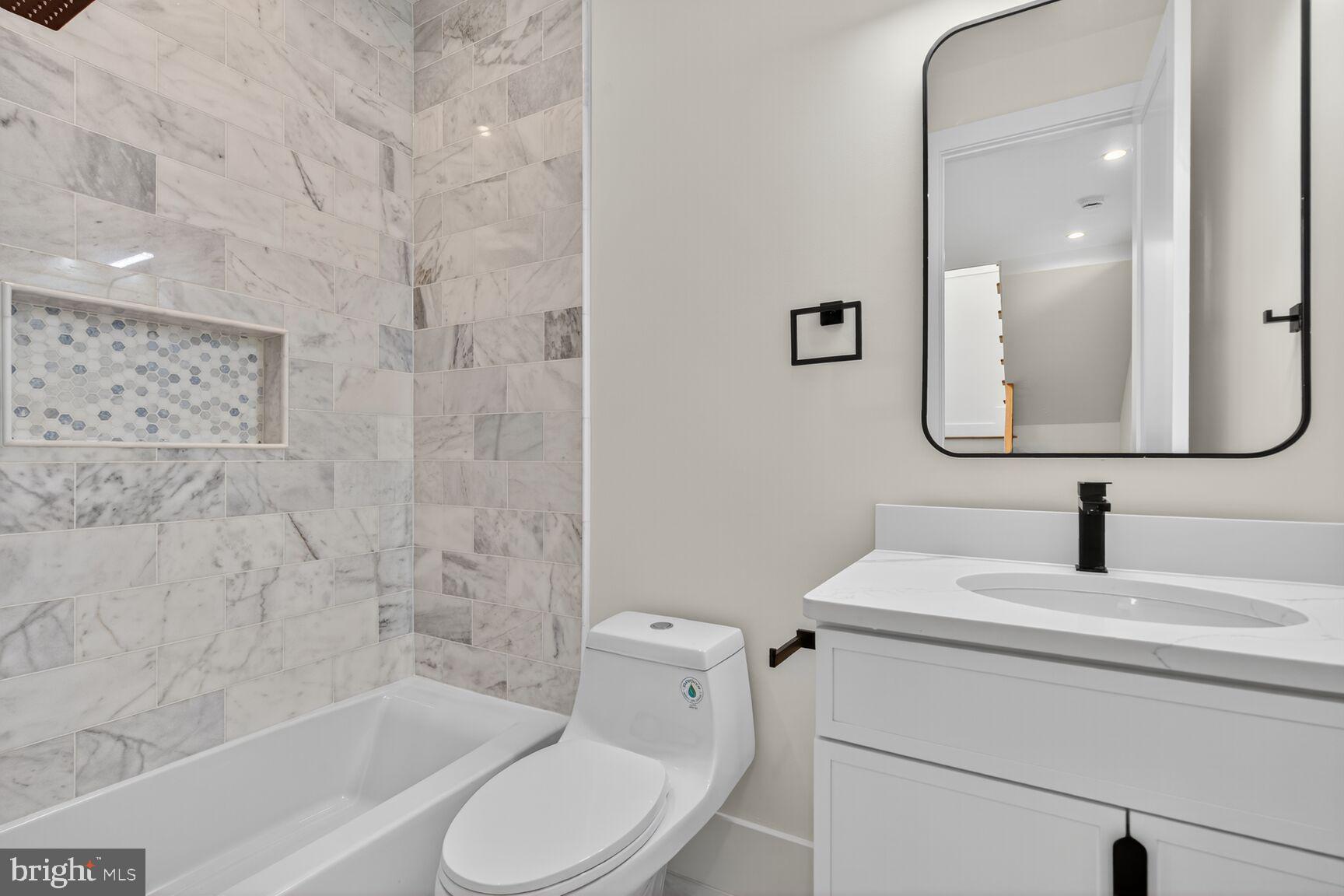 1209 Decatur Street Northwest Washington, DC 20011 - Photo 22 of 54 a bathroom with a toilet sink and mirror