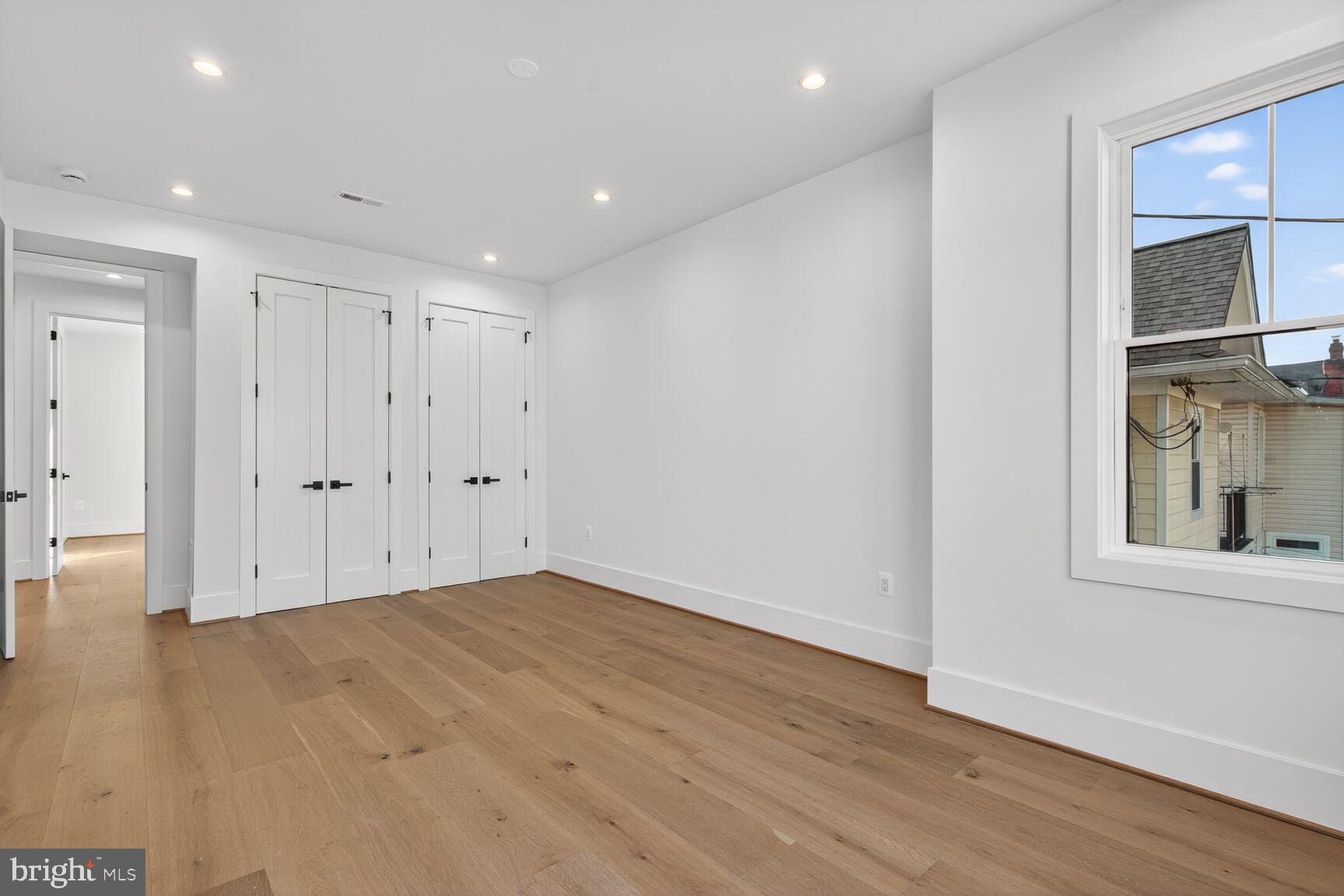 1209 Decatur Street Northwest Washington, DC 20011 - Photo 30 of 54 a view of an empty room with wooden floor and a window