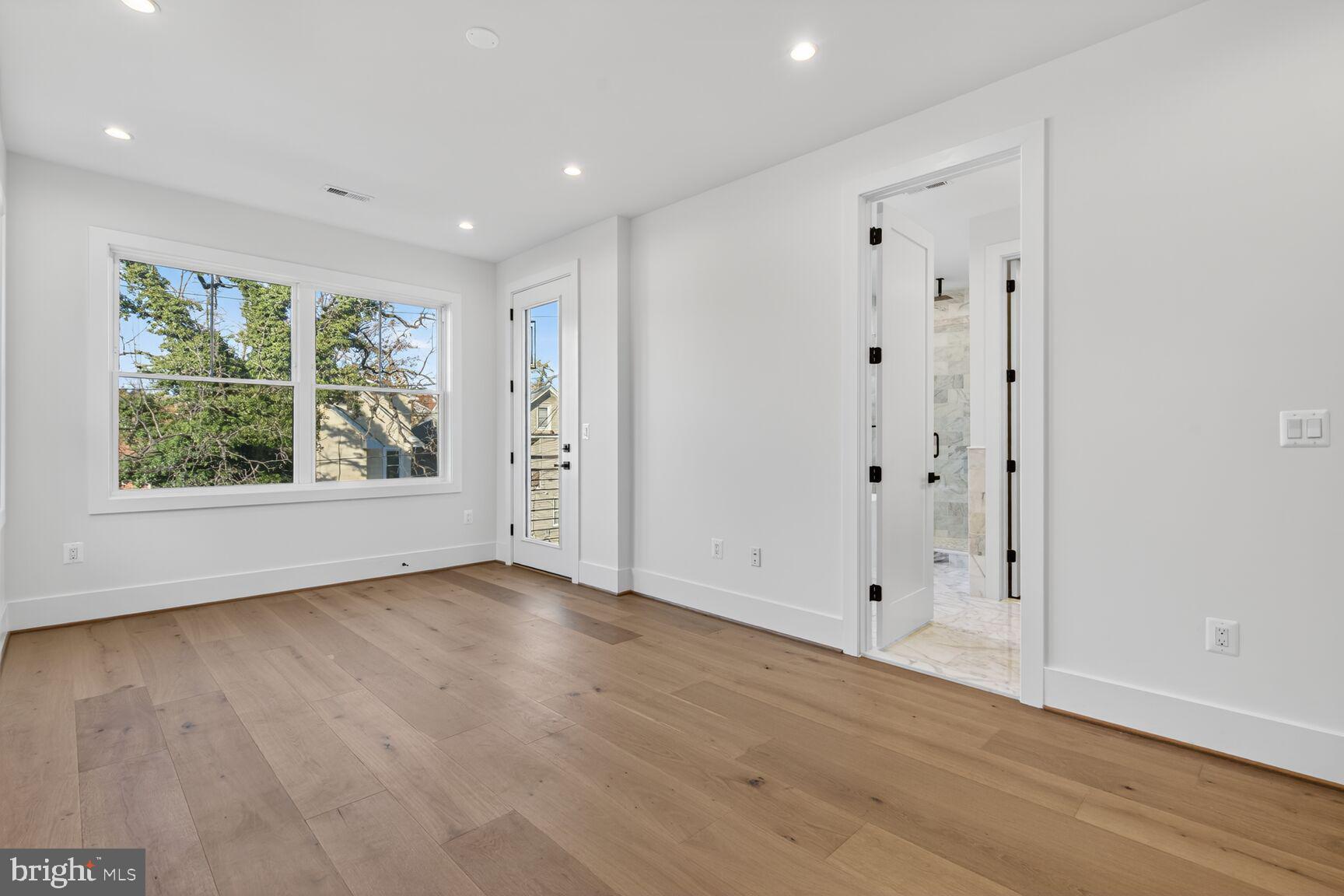1209 Decatur Street Northwest Washington, DC 20011 - Photo 31 of 54 a view of an empty room with wooden floor and window
