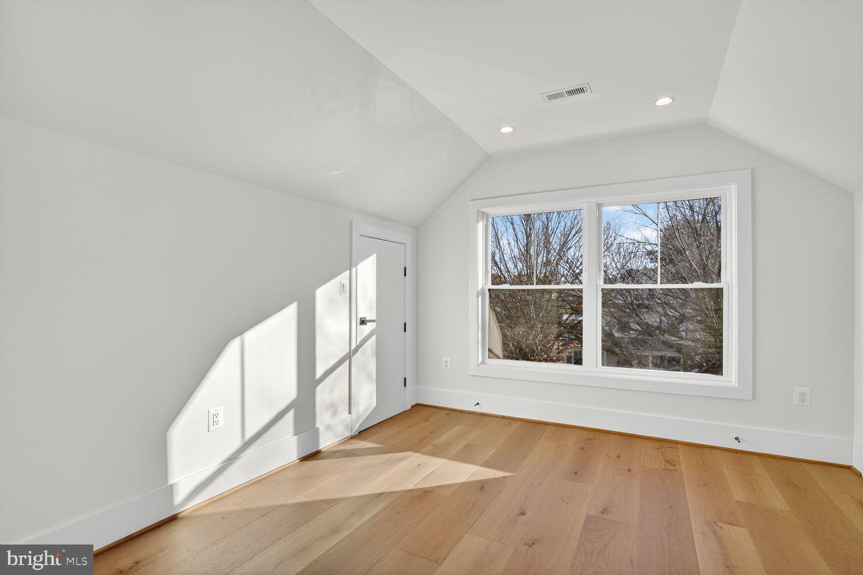 1209 Decatur Street Northwest Washington, DC 20011 - Photo 35 of 54 a view of an empty room with a window and hardwood floor