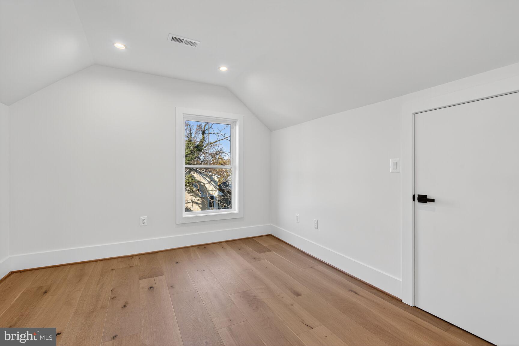 1209 Decatur Street Northwest Washington, DC 20011 - Photo 39 of 54 an empty room with wooden floor and window