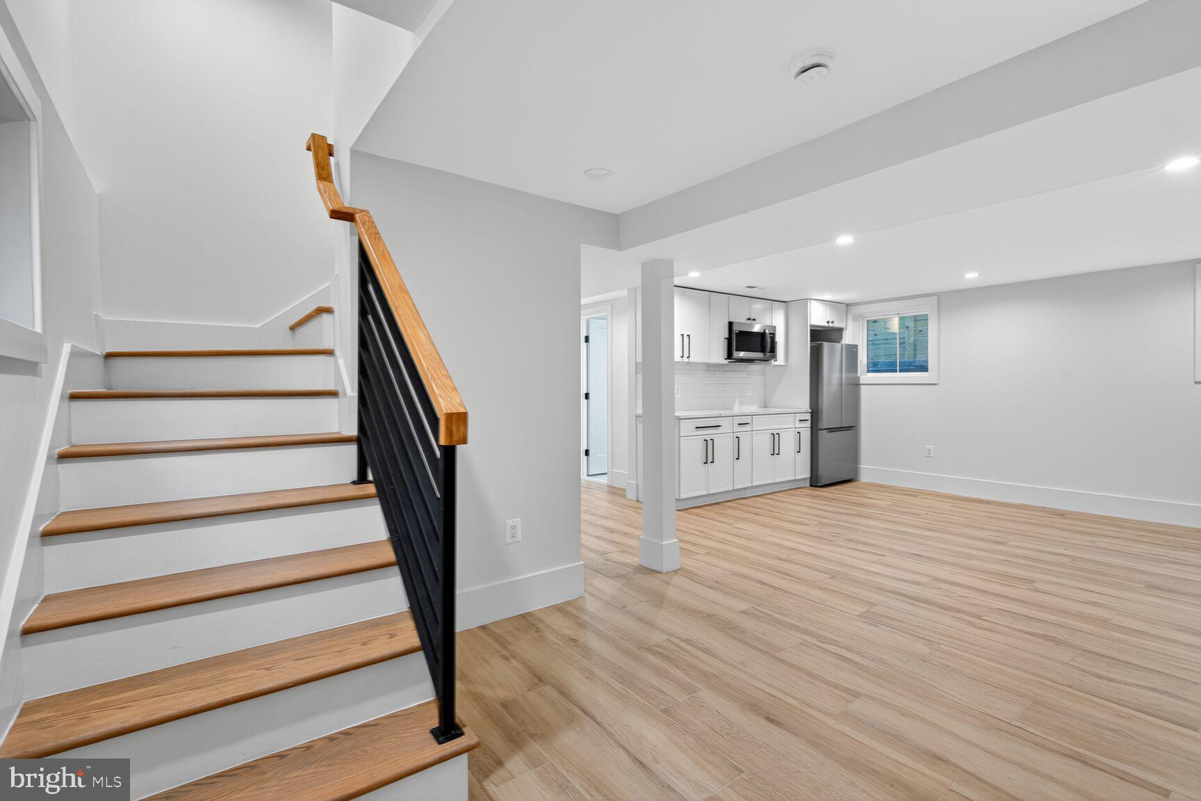 1209 Decatur Street Northwest Washington, DC 20011 - Photo 40 of 54 a view of empty room with wooden floor and kitchen