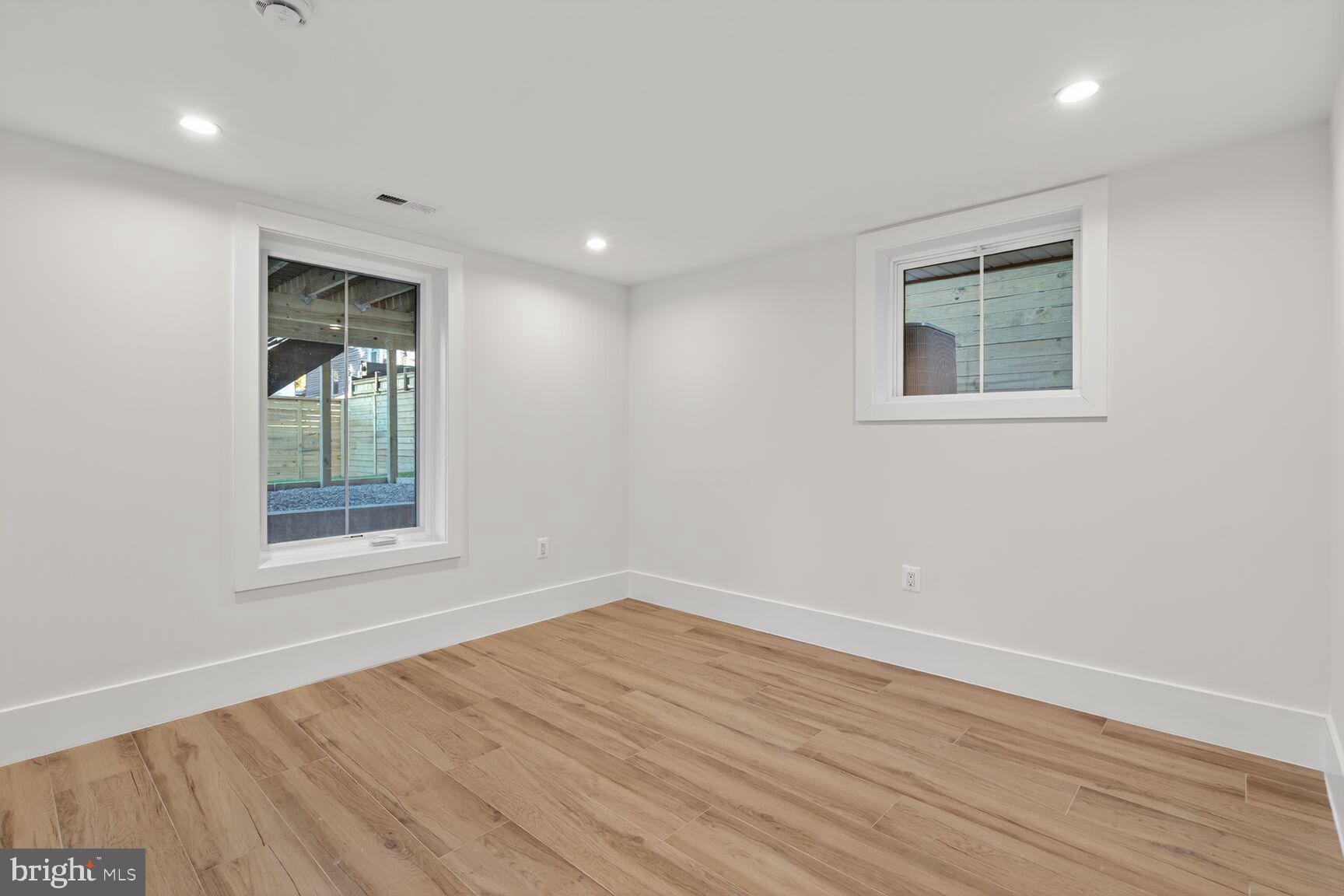 1209 Decatur Street Northwest Washington, DC 20011 - Photo 44 of 54 a view of an empty room with wooden floor and a window