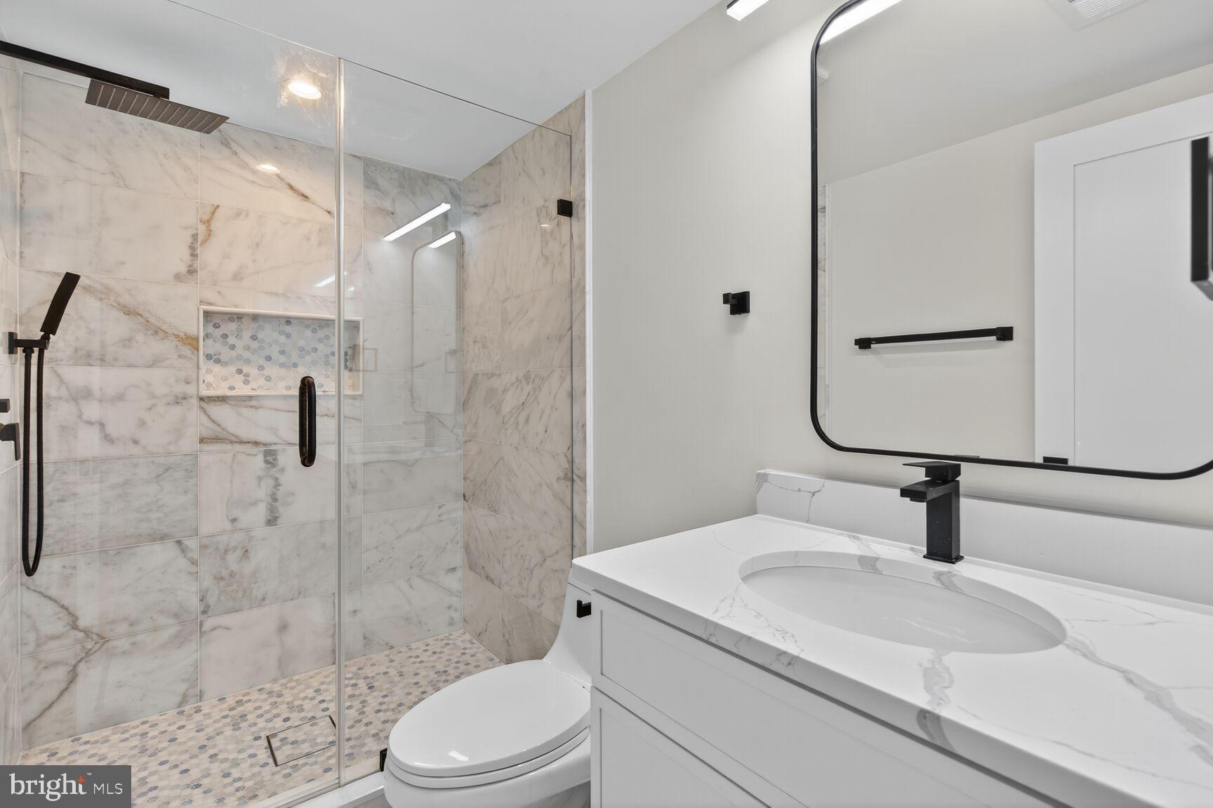 1209 Decatur Street Northwest Washington, DC 20011 - Photo 45 of 54 a bathroom with a sink toilet and shower