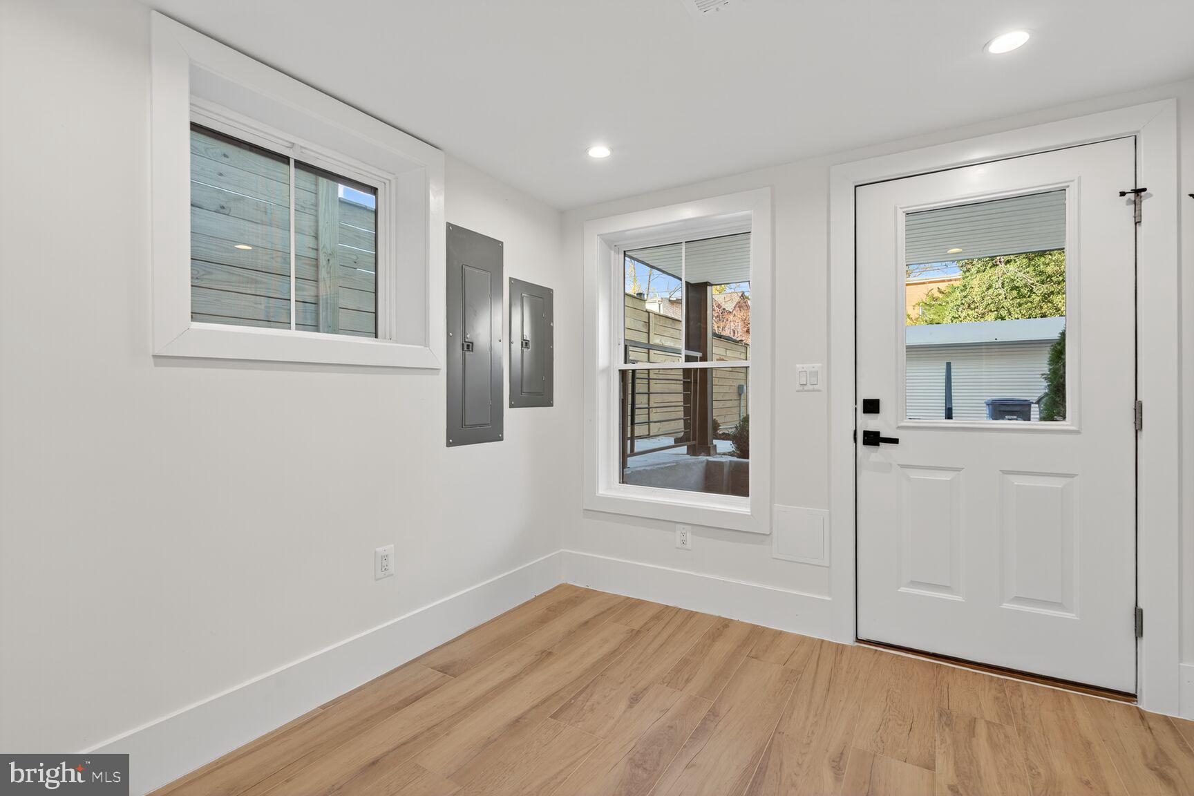 1209 Decatur Street Northwest Washington, DC 20011 - Photo 46 of 54 an empty room with window and wooden floor