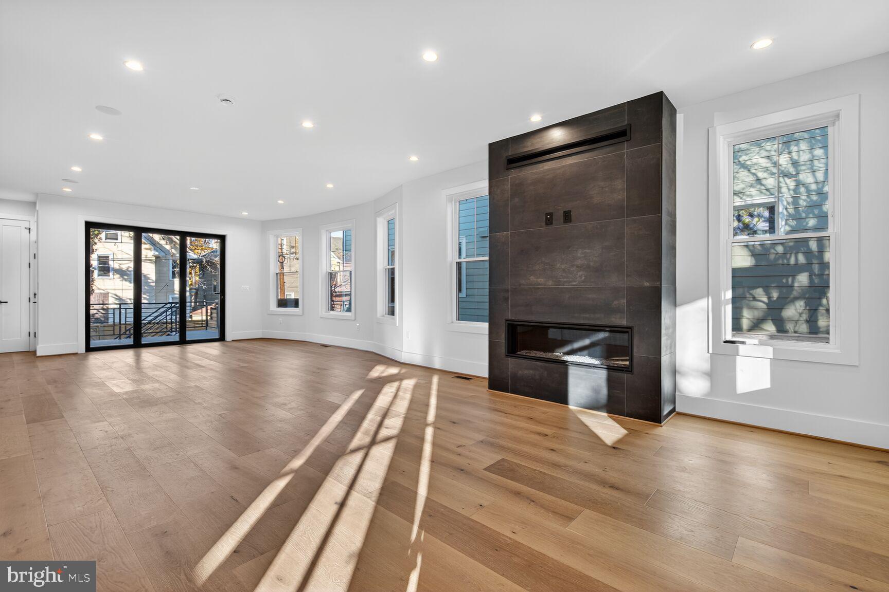 1209 Decatur Street Northwest Washington, DC 20011 - Photo 6 of 54 a view of an empty room with a fireplace and a window