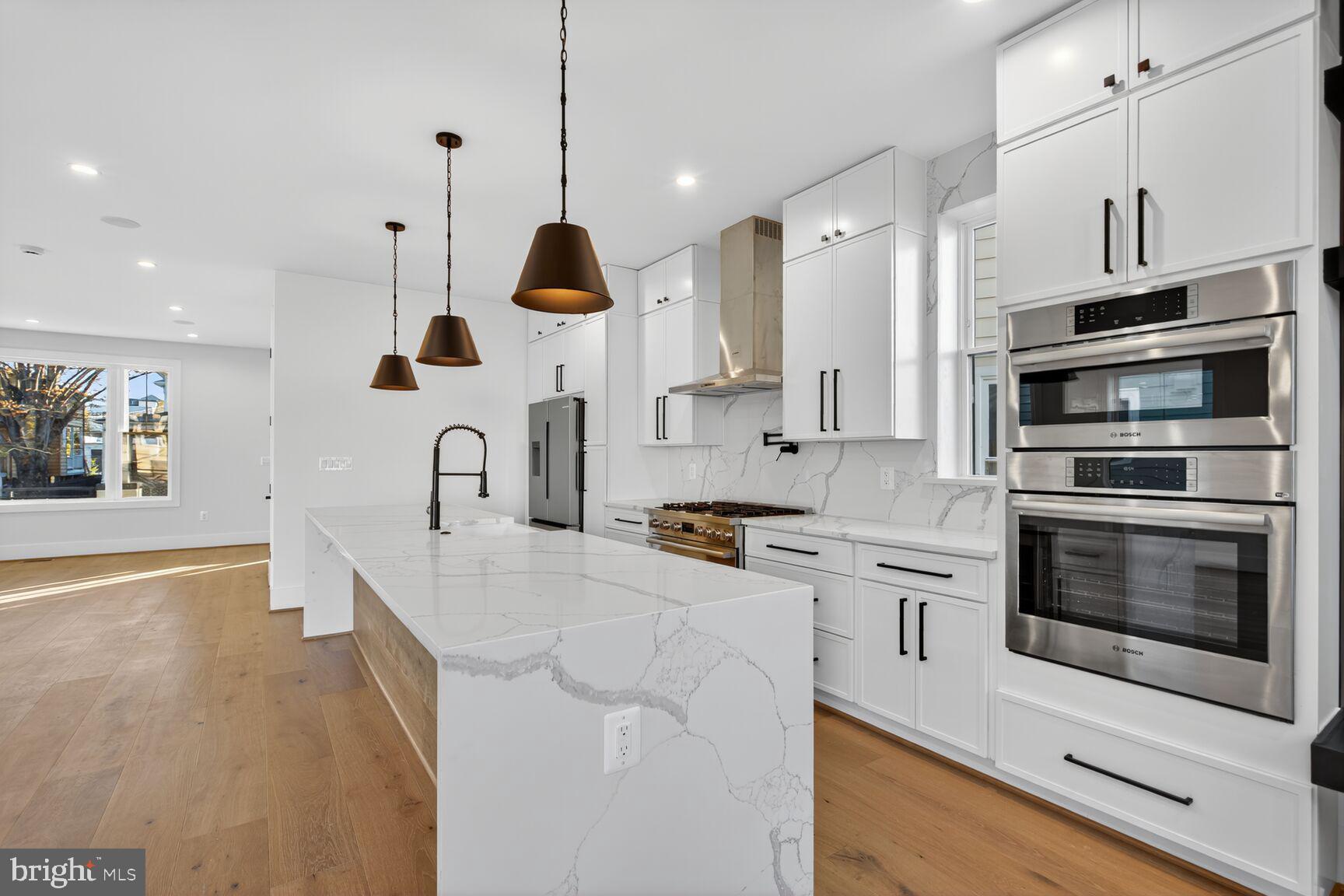 1209 Decatur Street Northwest Washington, DC 20011 - Photo 7 of 54 a large kitchen with stainless steel appliances and a wooden floor