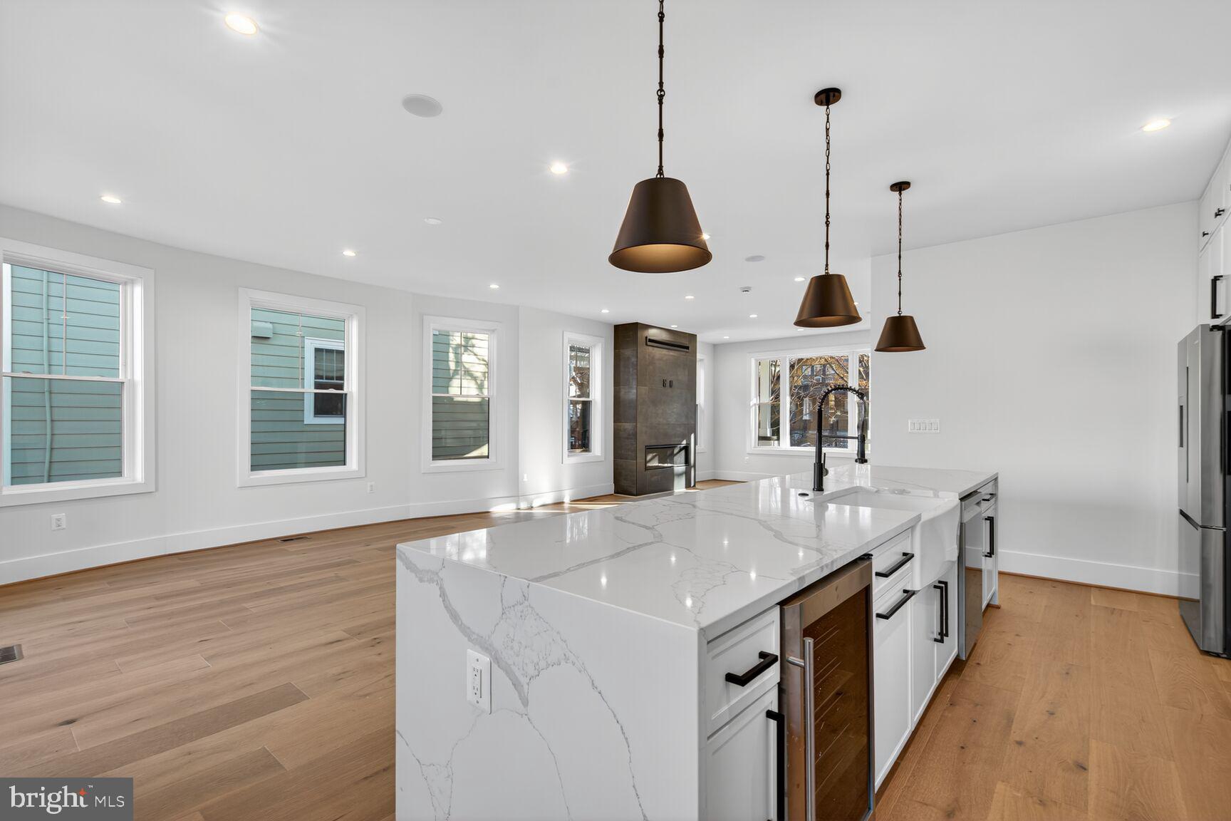 1209 Decatur Street Northwest Washington, DC 20011 - Photo 8 of 54 a kitchen with stainless steel appliances granite countertop a sink a oven and a large window