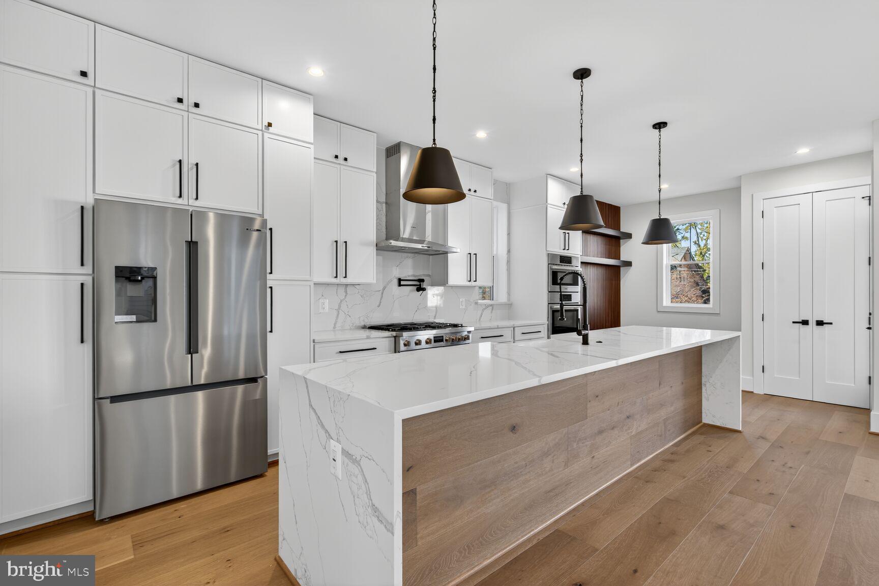 1209 Decatur Street Northwest Washington, DC 20011 - Photo 10 of 54 a kitchen with stainless steel appliances granite countertop a refrigerator a sink and a stove