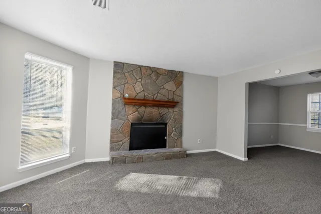 a view of empty room with a fireplace