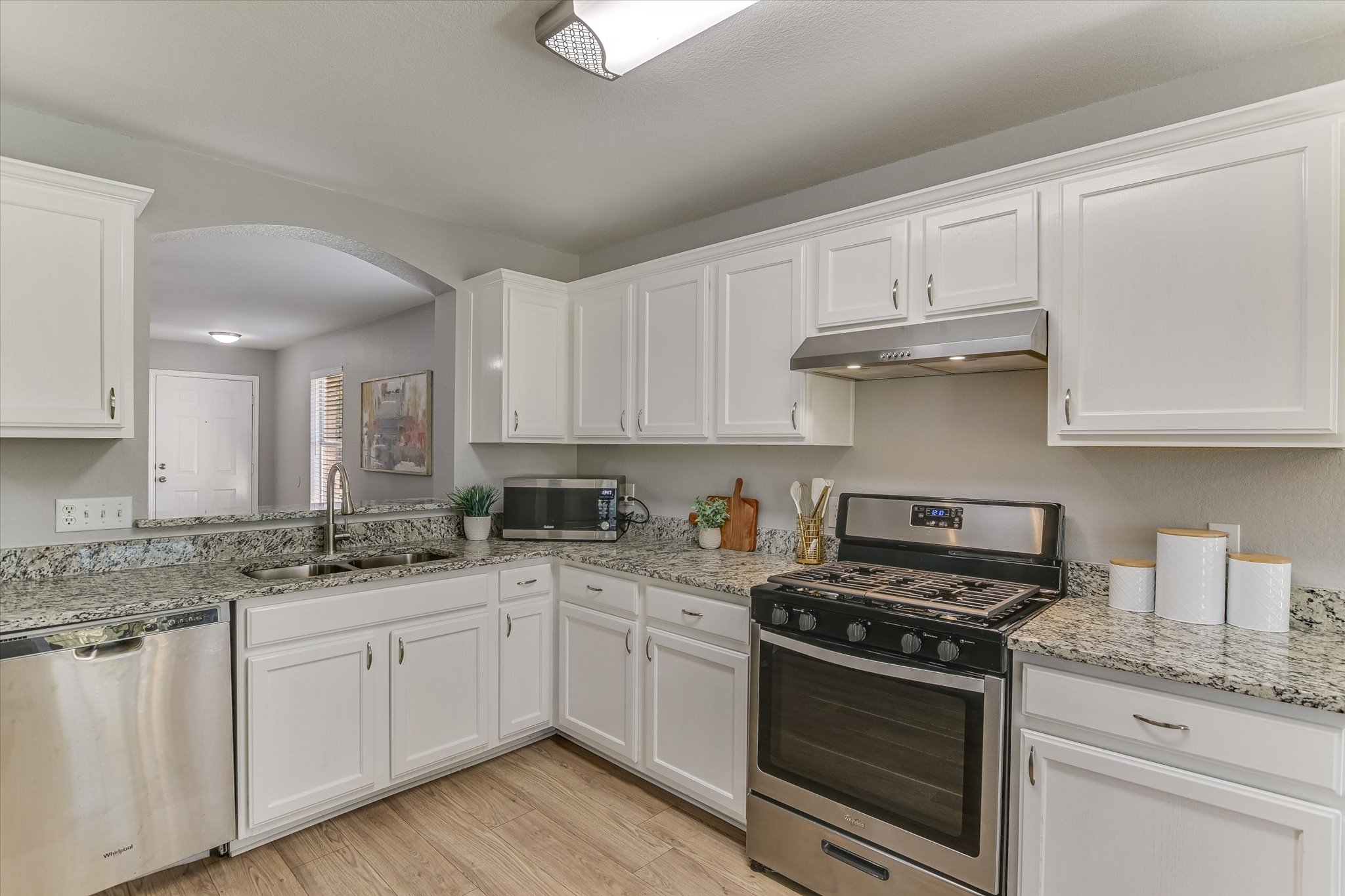 1520 Miss Allison's Way Pflugerville, TX 78660 - Photo 8 of 20 a kitchen with granite countertop white cabinets and white stainless steel appliances