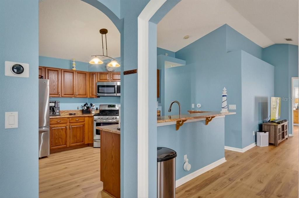 630 Fawn Ridge Drive Orange City, FL 32763 - Photo 11 of 55 a view of a kitchen center island and wooden floor