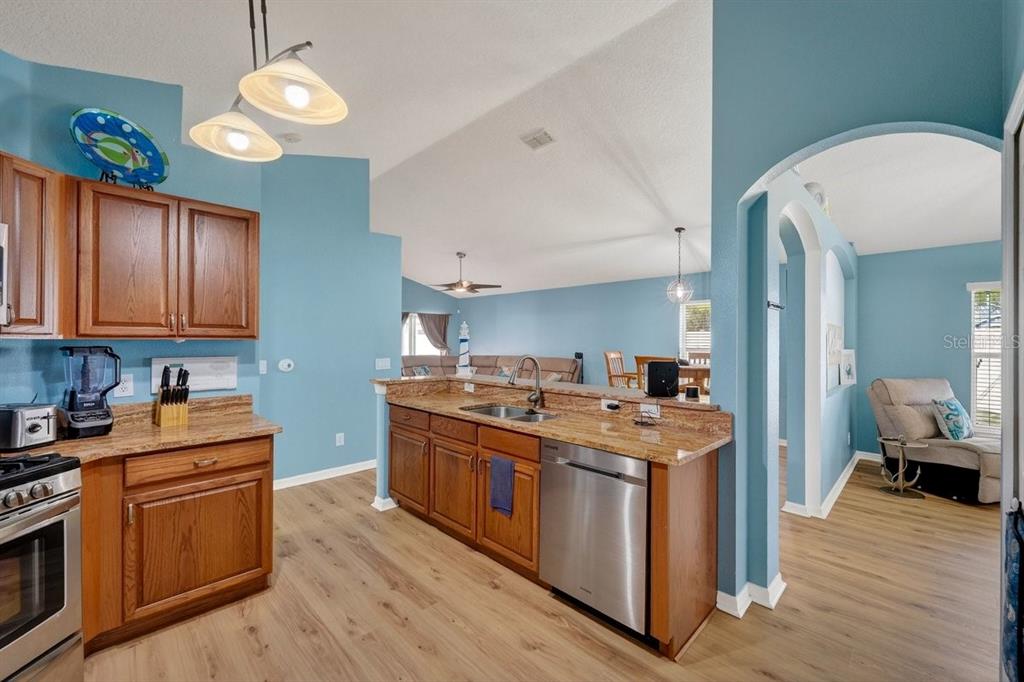 630 Fawn Ridge Drive Orange City, FL 32763 - Photo 16 of 55 a kitchen with stainless steel appliances granite countertop a stove and a wooden floors