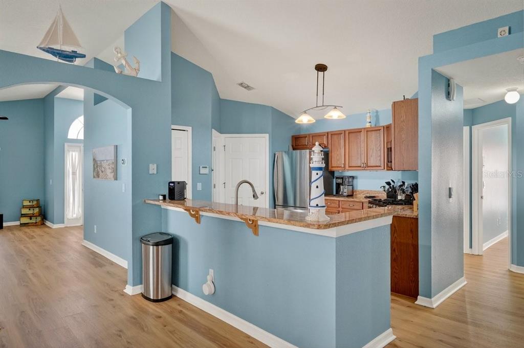 630 Fawn Ridge Drive Orange City, FL 32763 - Photo 17 of 55 a kitchen with stainless steel appliances granite countertop a sink a refrigerator and a stove