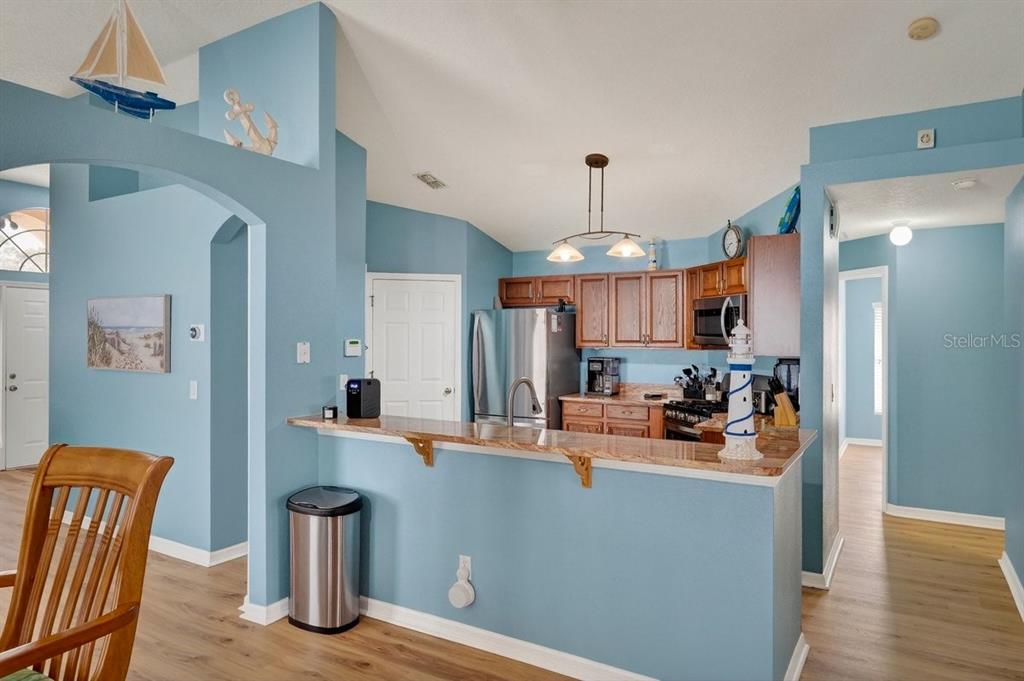 630 Fawn Ridge Drive Orange City, FL 32763 - Photo 18 of 55 a room with stainless steel appliances kitchen island granite countertop a sink and a refrigerator