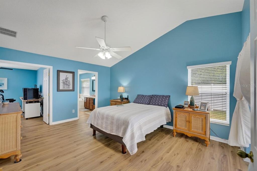 630 Fawn Ridge Drive Orange City, FL 32763 - Photo 25 of 55 a bedroom with a bed and wooden floor