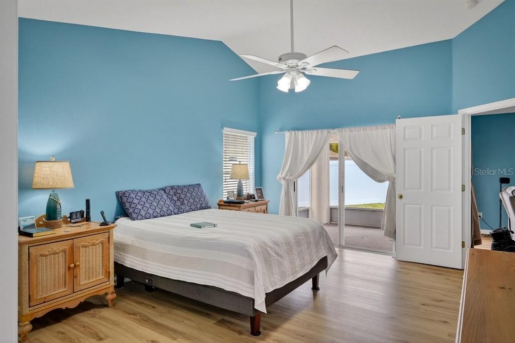 630 Fawn Ridge Drive Orange City, FL 32763 - Photo 27 of 55 a bedroom with a large bed and a chandelier