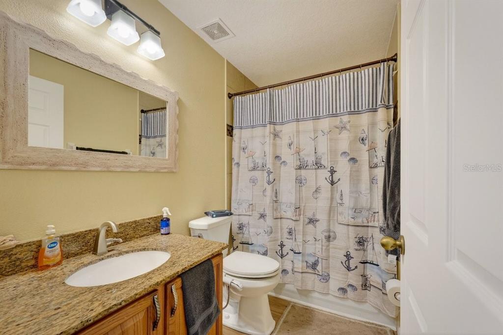 630 Fawn Ridge Drive Orange City, FL 32763 - Photo 38 of 55 a bathroom with a granite countertop sink toilet and shower